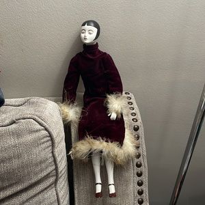 Porcelain doll maroon clothing